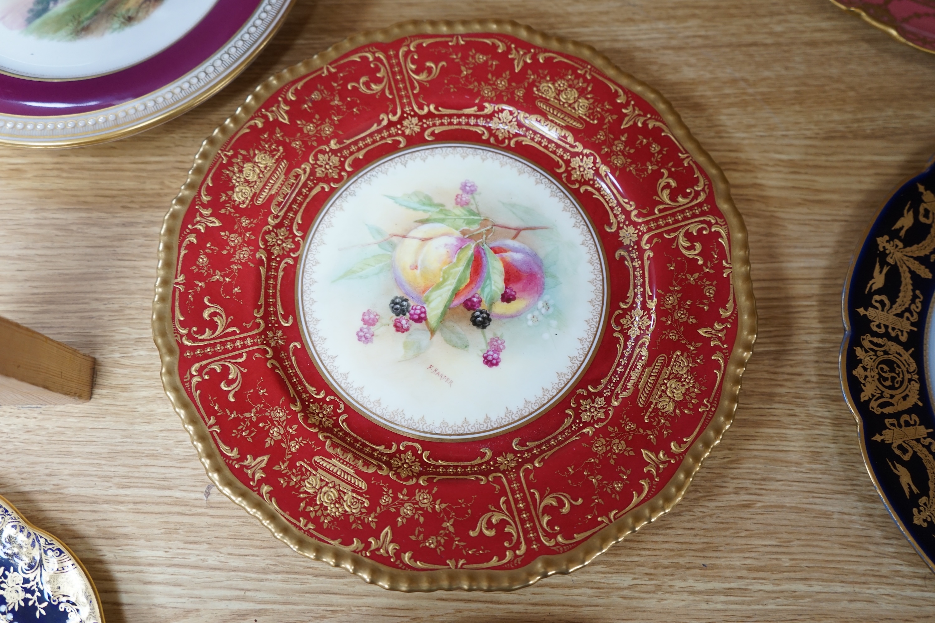 A collection of English porcelain plates, highlights include a Royal Doulton fruit painted cabinet plate signed F Harper, a Royal Worcester flower painted cabinet plate signed E Phillips, and Aynsley plate painted with a